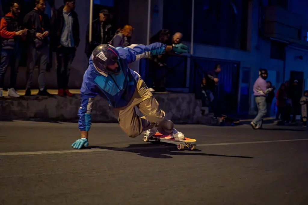 Rider de longboard derrapando durante una sesión nocturna.